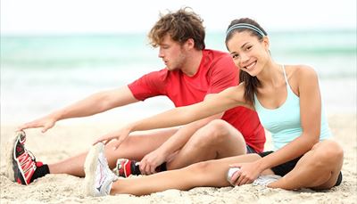 man, smile, couple, exercise, sneakers, woman, stretch, t-shirt, sand, beach