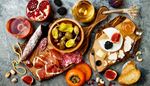 rope, pomegranate, persimmon, jamon, pistachios, brie, bread, teaspoon, wine, blackberry, sausage, olives, fig, fork, cashew