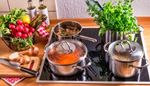 radish, cuttingboard, stove, saucepans, lid, asparagus, pan, soup, knife, lemon, onion, zucchini