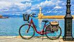 basket, handlebars, lighthouse, bicycle, bikestand, bikeframe, lamppost, seat, cyan, pedal, sea