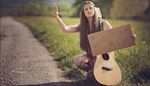 hitchhiker, peacesymbol, hippy, flower, strings, knee, guitar, cardboard, road, grass, arm