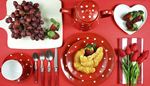 teaset, strawberries, croissant, utensils, napkin, grapes, tulips, knife, fork, red