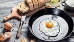 fryingpan, cuttingboard, eggshell, oil, friedegg, breakfast, bread, knife